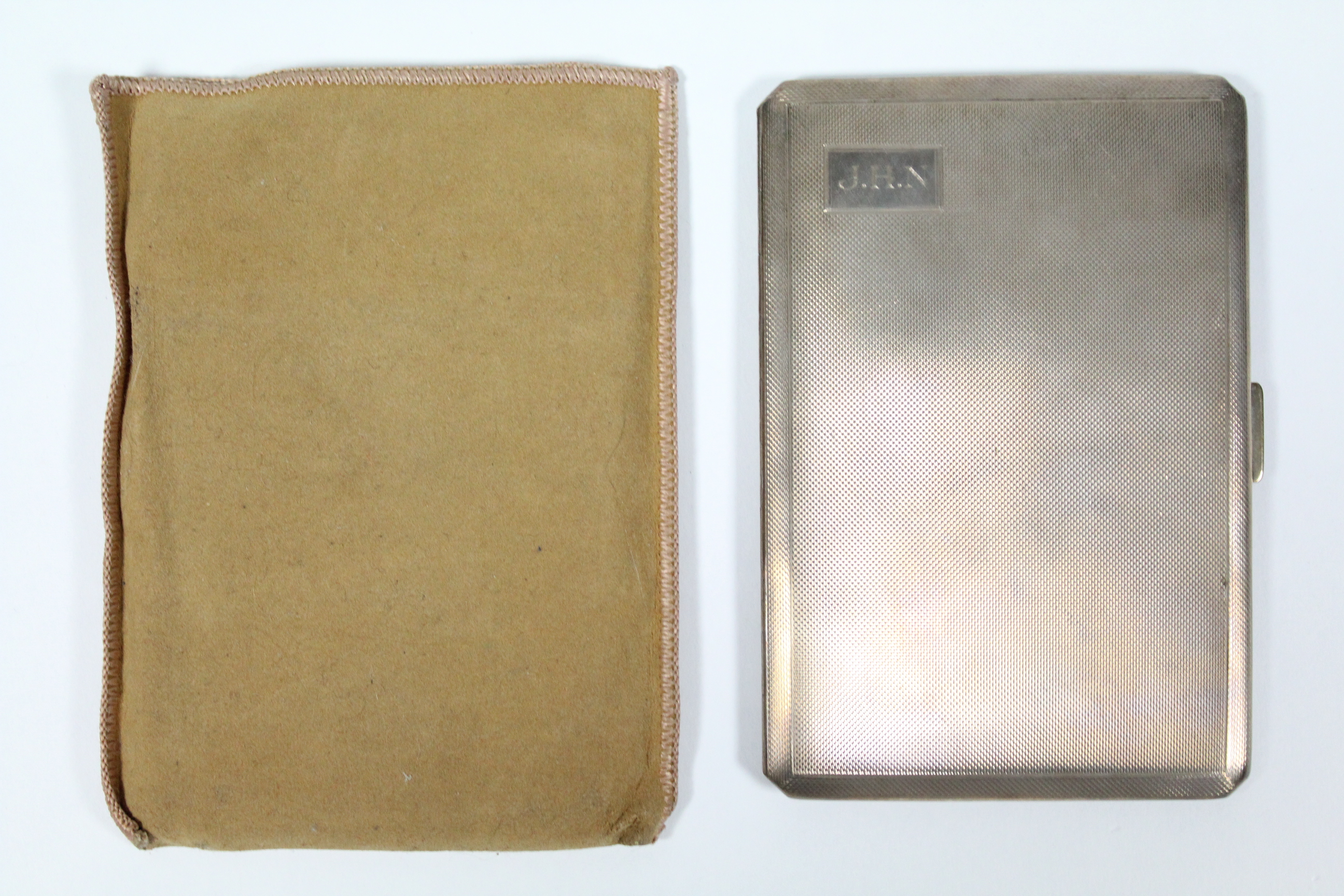 A silver rectangular engine-turned pocket cigarette case, 5” x 3¼2; Birmingham 1950, by D. Bros. (