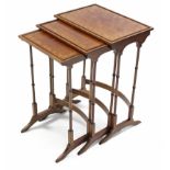 An Edwardian mahogany inlaid nest of three tables with slender ring-turned supports, 20” wide x