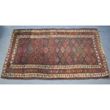 A Caucasian rug of crimson & ivory ground, with repeating geometric design within multiple floral