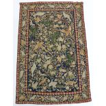 A 20th century Indian crewel-work wall hanging decorated with exotic birds amongst flowers on a dark