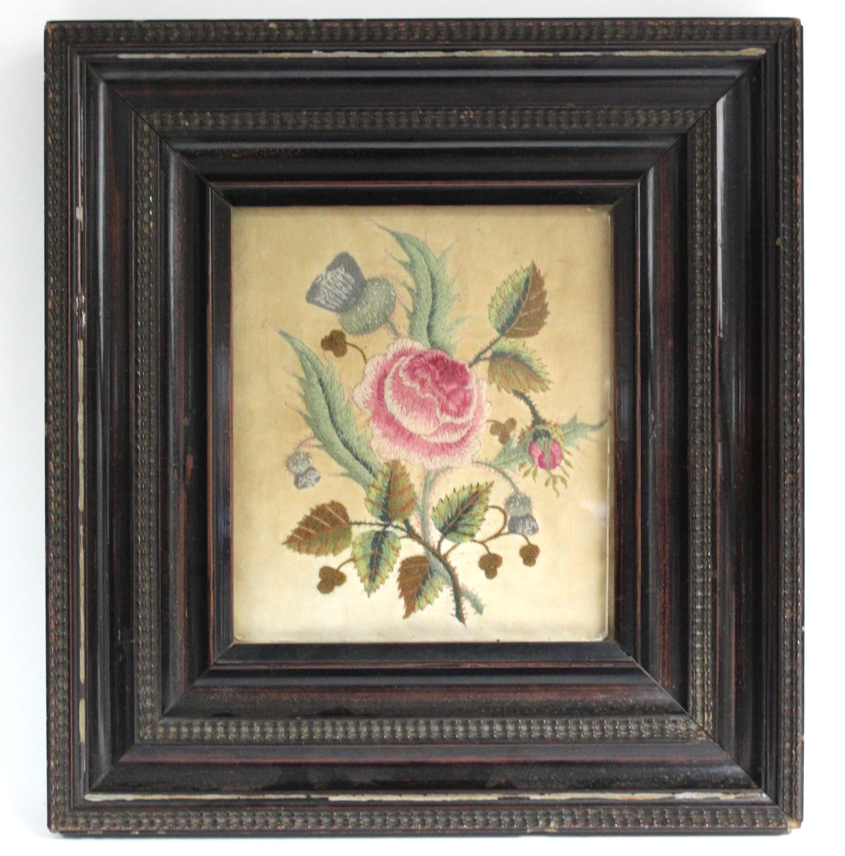 A 19th century embroidered needlework depicting the Scottish thistle, English rose, & Irish