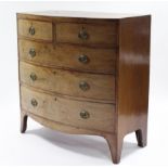 An early 19th century mahogany bow-front chest with crossbanded top, fitted two short & three long