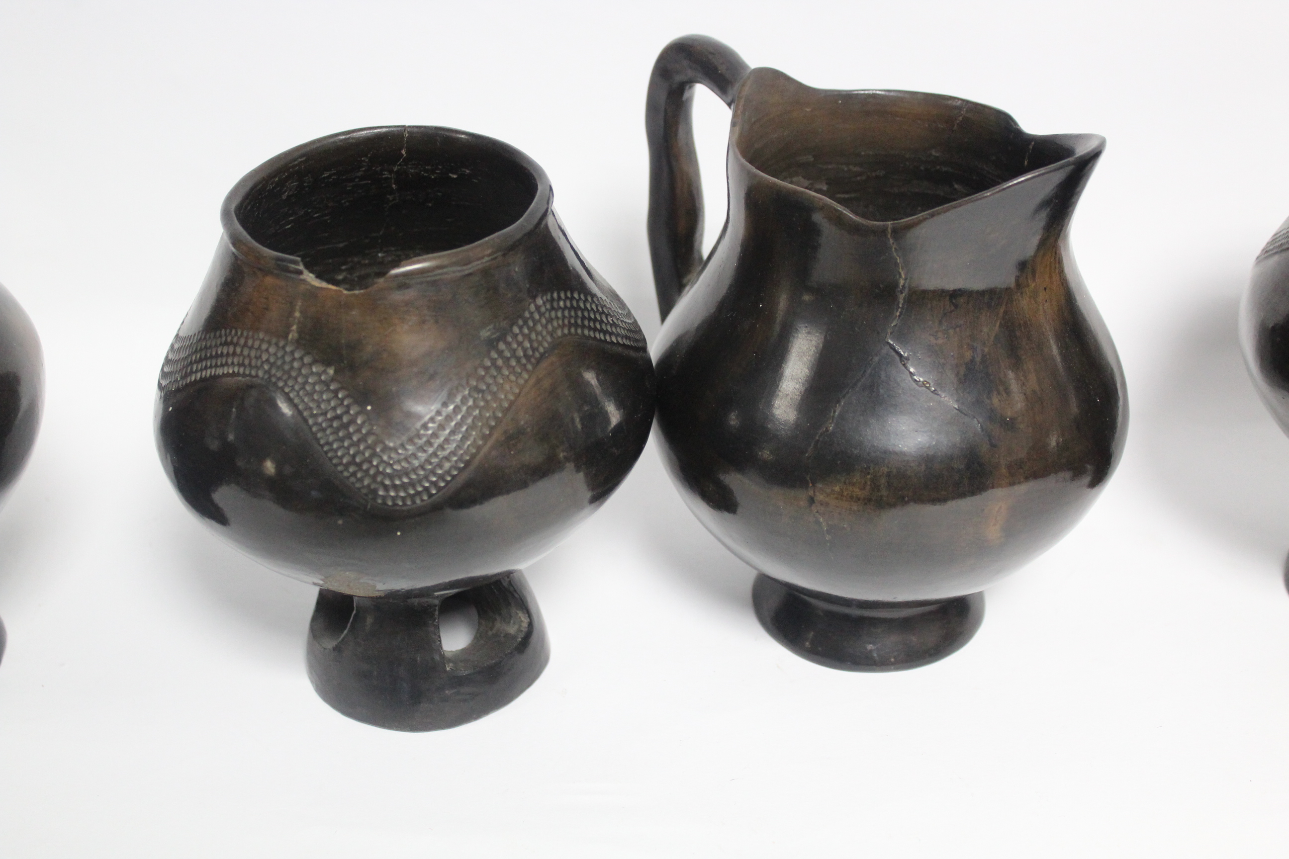 A group of four dark brown glazed earthenware vessels, each on pierced foot, 6” high; & a similar - Image 2 of 2