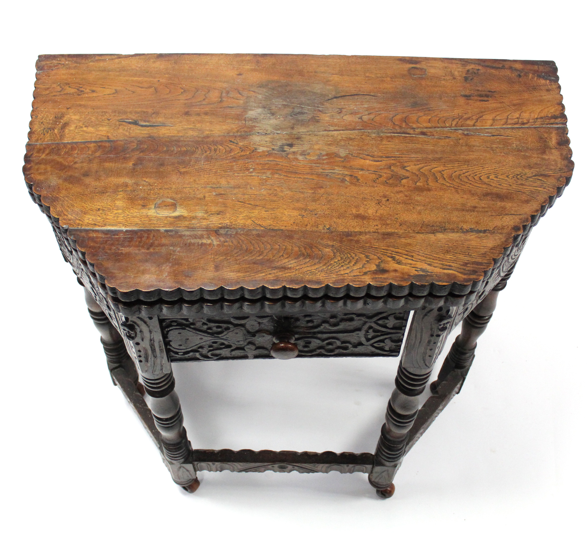 A 17th century-style carved oak credence table with fold-over top, shaped edge, fitted frieze - Image 4 of 4