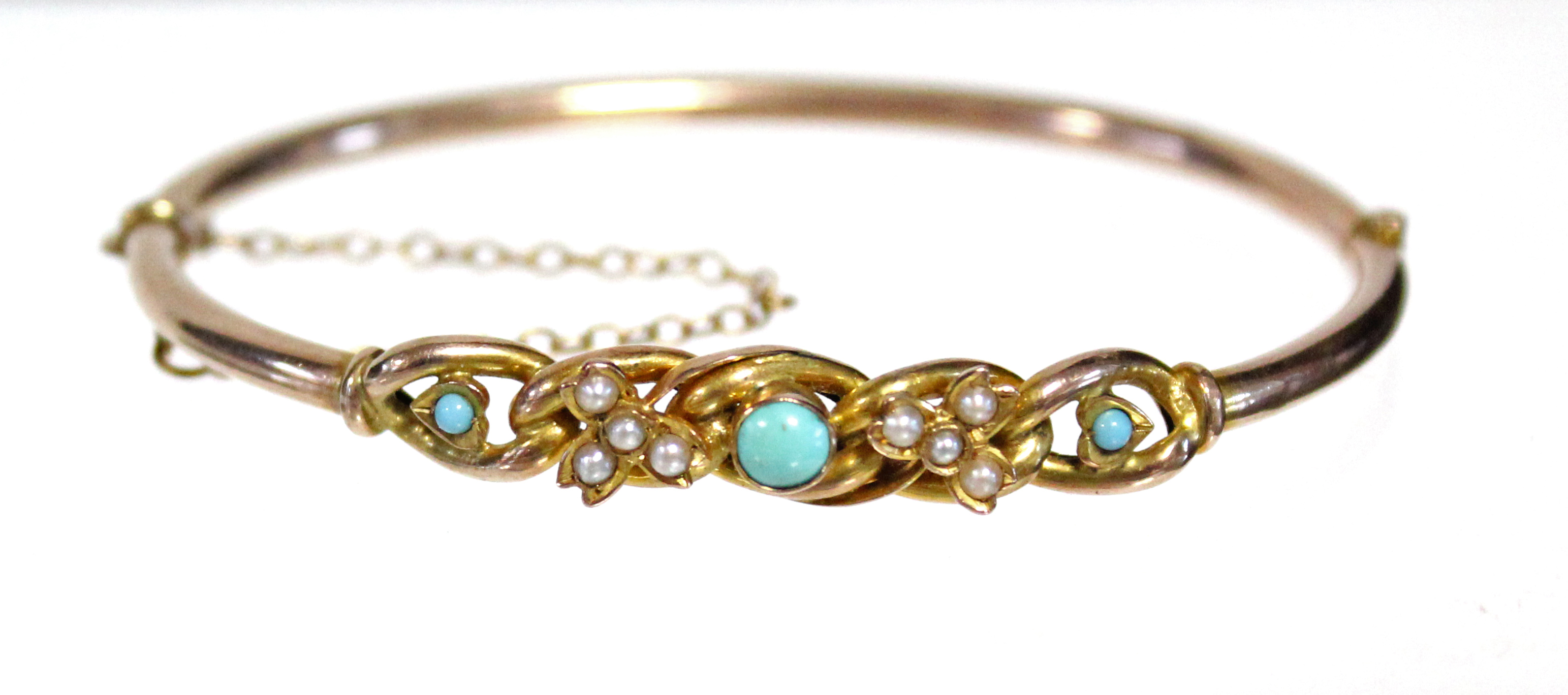 A 9ct. gold stiff hinged hollow bangle set turquoise beads & seed pearls. (5.6gm gross).