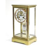A 19th century French four-glass mantel clock in gilt-brass case, the 4” diam. white enamel two-part
