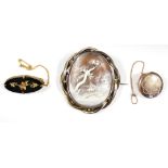 A late 19th/early 20th century 9ct. gold & black onyx oval brooch with applied leaf decoration; a