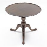 A George II-style mahogany tripod table, the circular tilt-top with pie-crust edge, on vase-turned