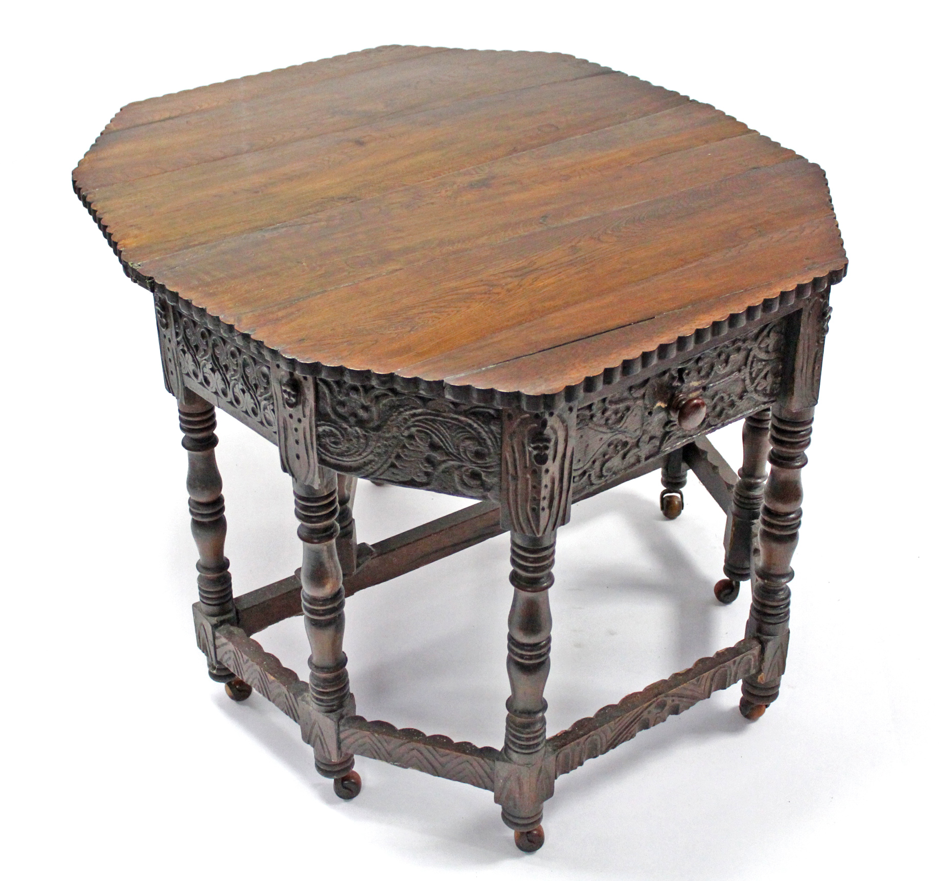 A 17th century-style carved oak credence table with fold-over top, shaped edge, fitted frieze - Image 2 of 4