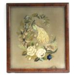 An early 19th century needlework picture of a bird amongst flowers; 15” x 13”, in glazed frame.