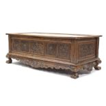 A 19th century INDONESIAN SOLID HARDWOOD CHEST, profusely carved to all sides with floral &