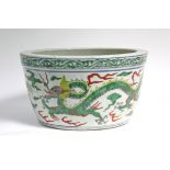 A Chinese porcelain jardinière, decorated in doucai enamels with dragons chasing the flaming