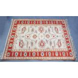 A Turkish Konya rug of ivory ground, with central foliate design within a rust-red border; 74” x