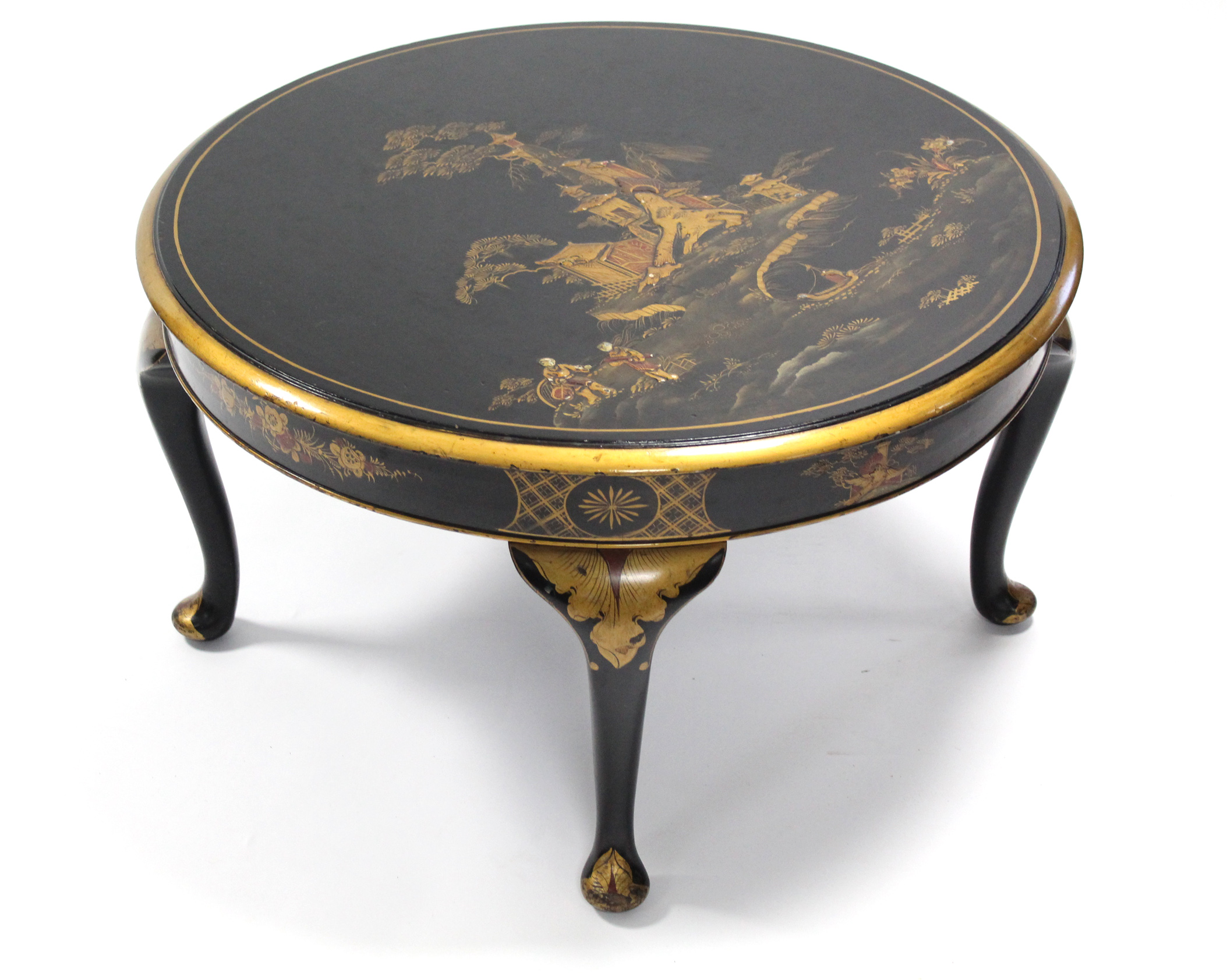 A black-lacquer circular low occasional table with gilt Chinoiserie decoration, on cabriole legs