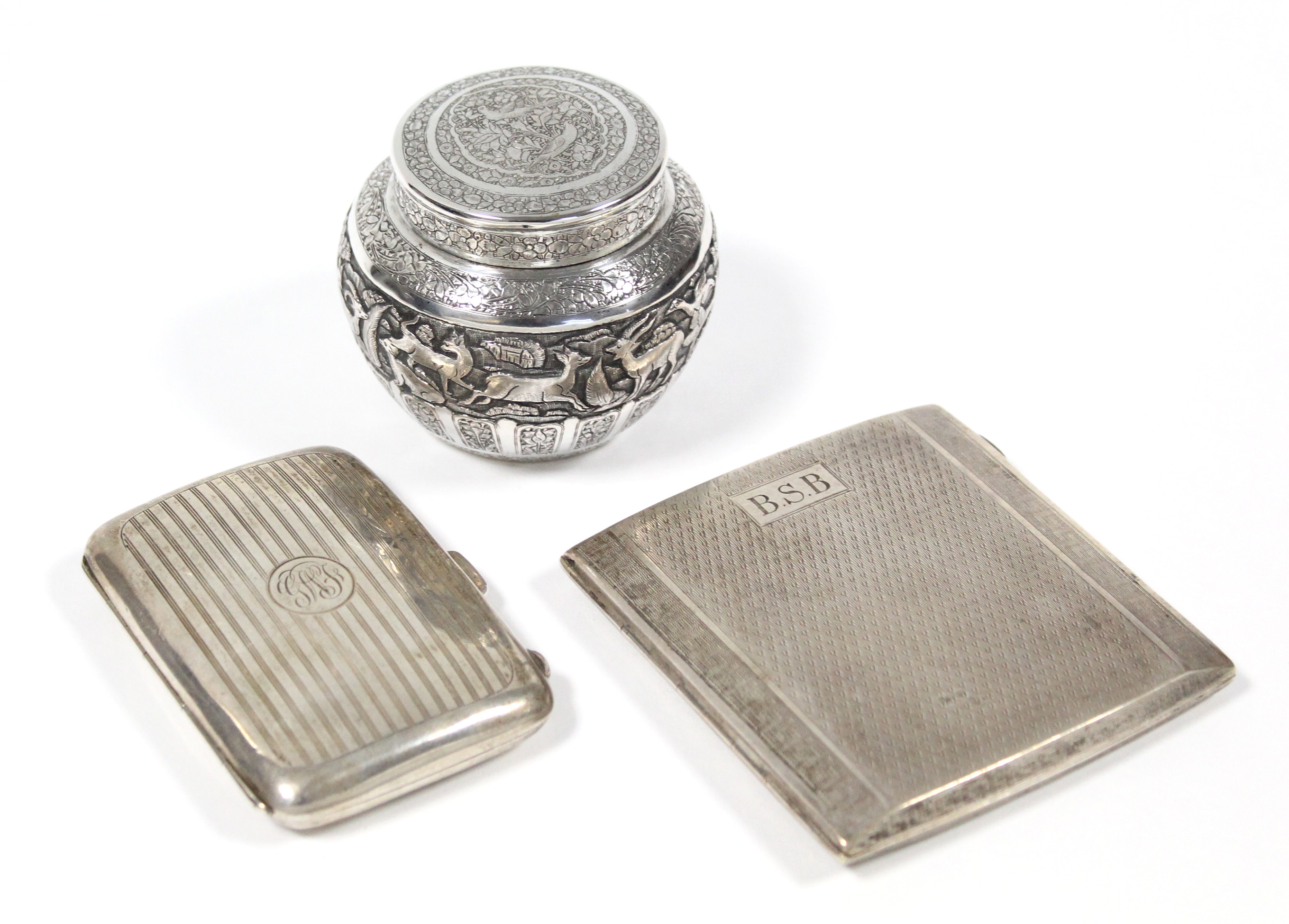 An engine-turned pocket cigarette case, Birmingham 1932; another 1923 (5 oz total); & an Indian