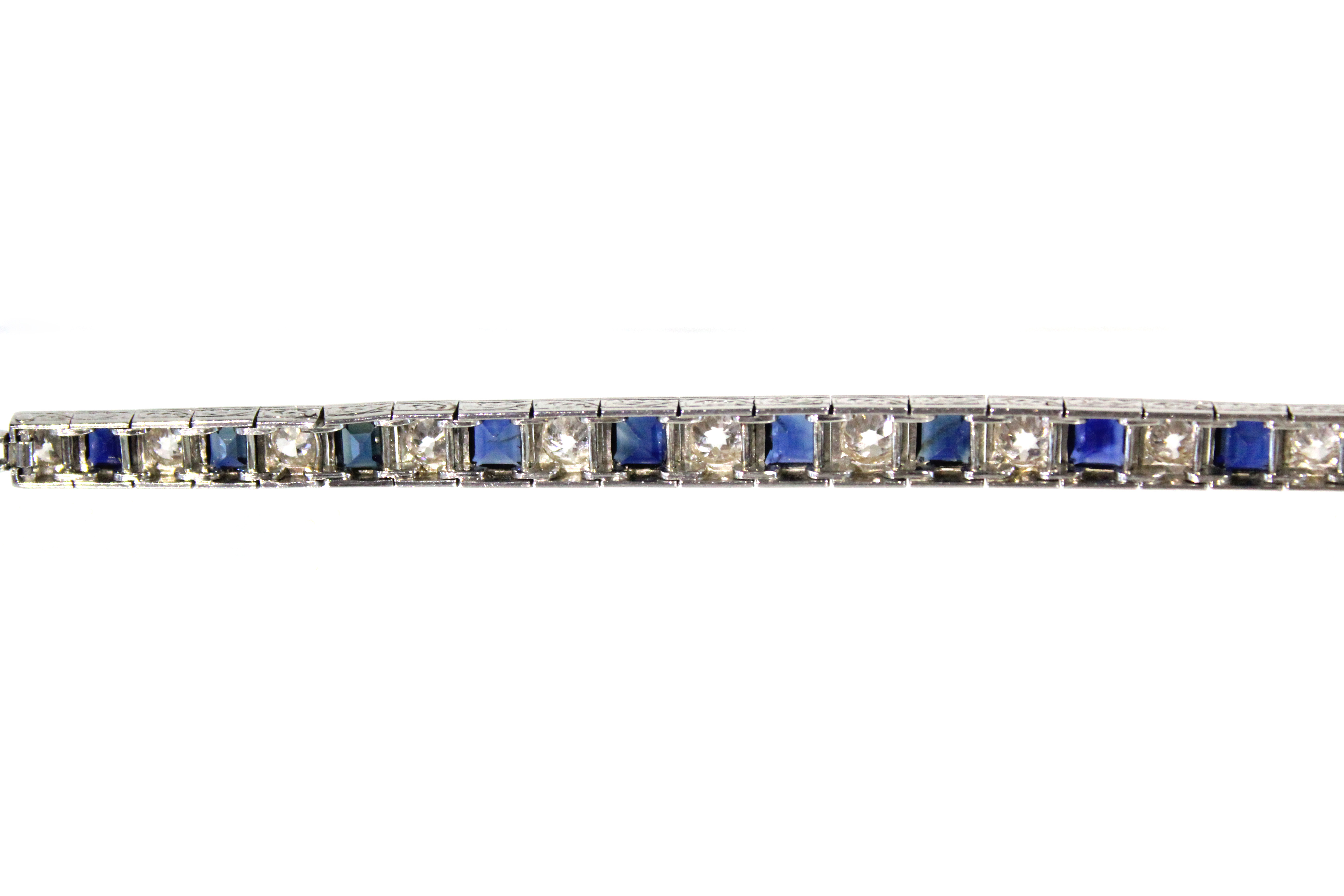 AN ART DECO PLATINUM, DIAMOND, & SAPPHIRE EXPANDING BRACELET, the thirteen graduated pavé-set - Image 4 of 7