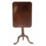 An early 19th century mahogany tripod table, the rectangular tilt-top with canted corners, on