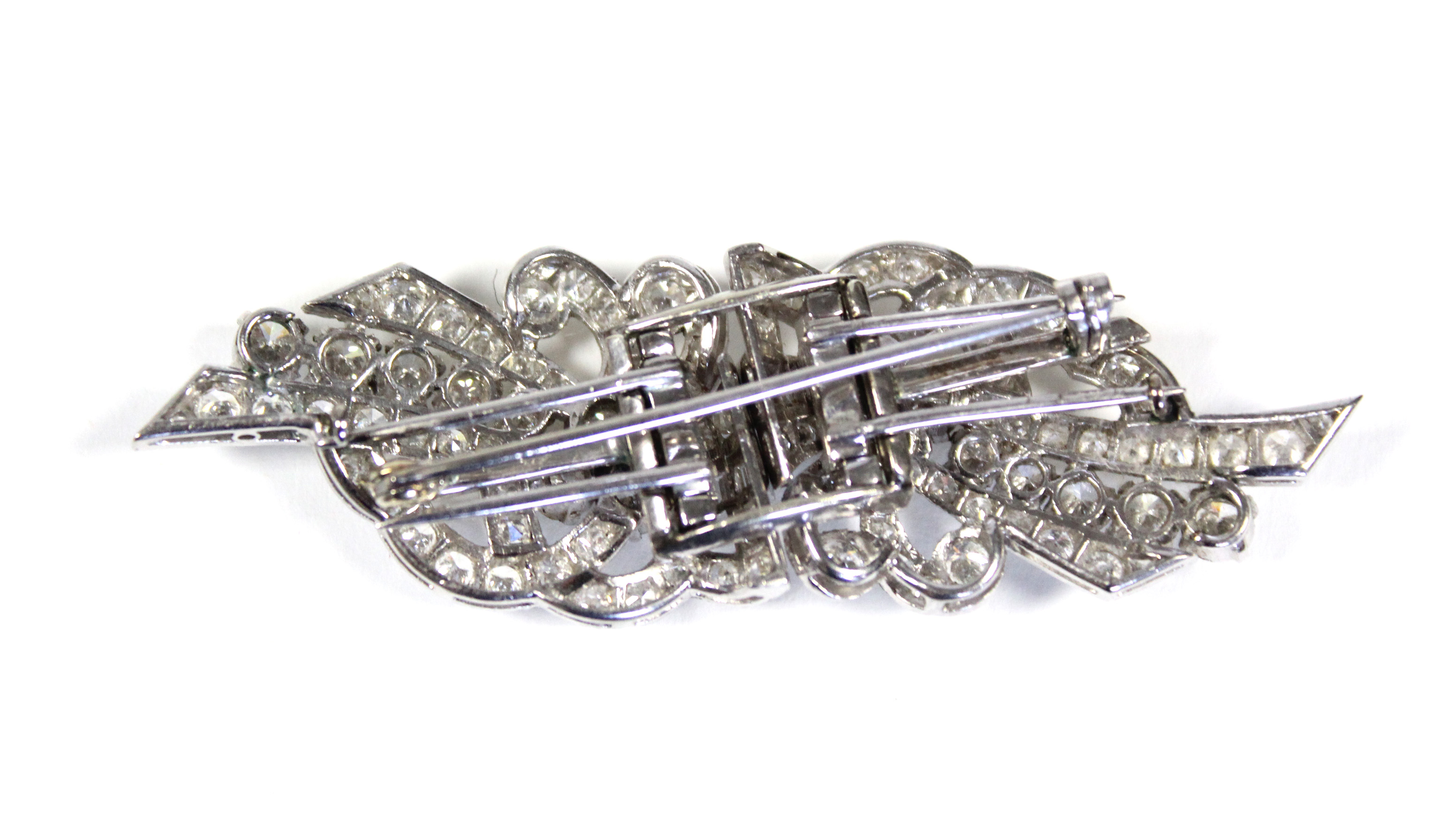 A PLATINUM & DIAMOND DOUBLE-CLIP BROOCH of scroll design, set approximately 102 round & baguette-cut - Image 3 of 4