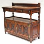 A late Victorian carved mahogany two-tier dumb waiter by Gillow & Co., fitted two frieze drawers