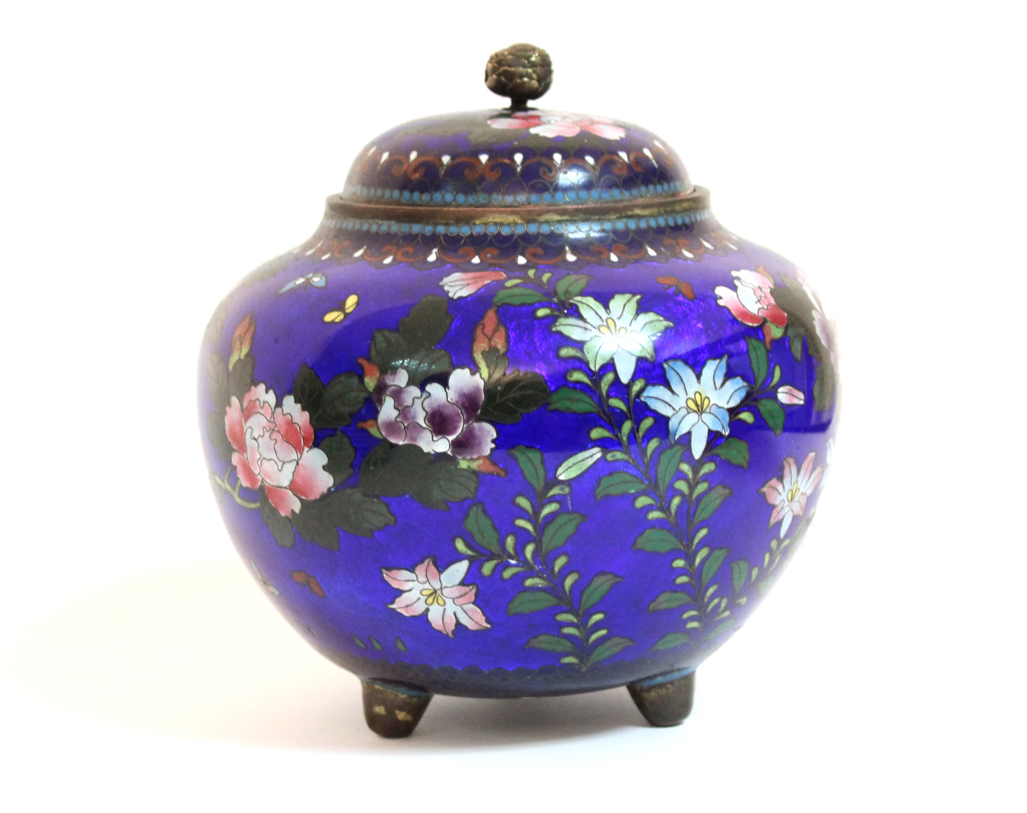 A late 19th century Chinese cloisonné squat round vase & cover with all-over decoration of flowers &