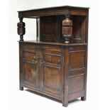 A 17th century-style joined oak court cupboard, the upper part with craved frieze & central panel