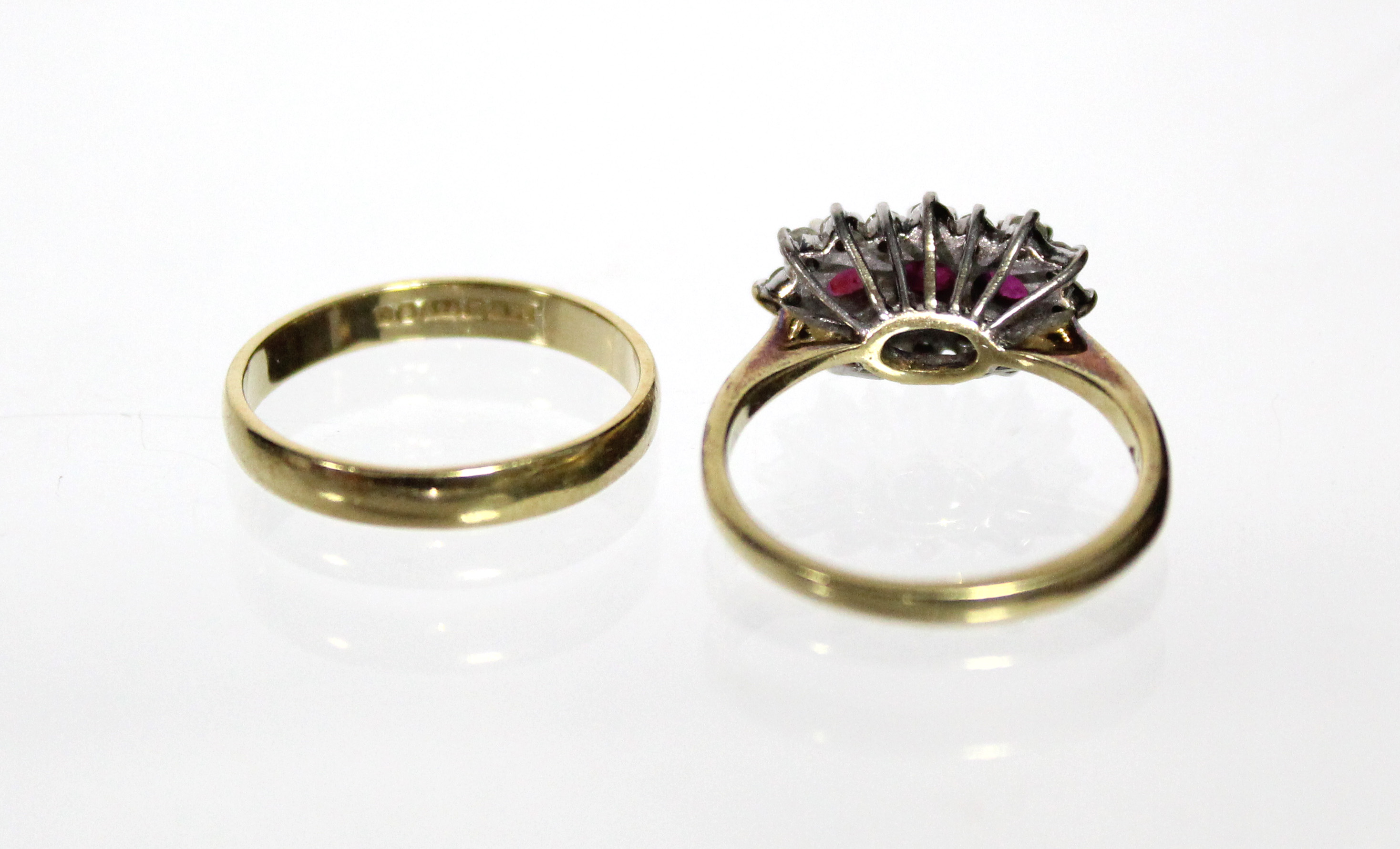 An 18ct. gold ring set three rubies within a border of small diamonds (Size: M); & an 18ct. gold - Image 5 of 5