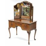 An 18th century-style walnut dressing table with triple-panel mirror back, fitted three frieze