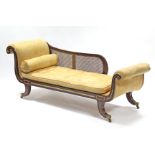 A REGENCY SIMULATED ROSEWOOD & PARCEL-GILT CHAISE LONGUE, with carved rosettes to the scroll ends,