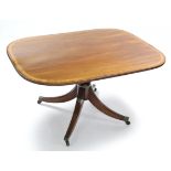 A Regency mahogany & satinwood-crossbanded breakfast table with rectangular tilt-top on turned