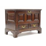 AN 18th century WELSH OAK COFFOR BACH, the triple-panel front fitted two drawers with original