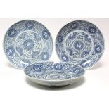 Three Chinese provincial blue & white porcelain large shallow dishes, each painted with a stylised