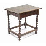 A late 17th/early 18th century oak side table fitted frieze drawer, on bobbin-turned legs with plain