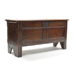 A late 17th century oak & elm coffer, with panelled front & hinged lift-lid, on stump feet; 45½”