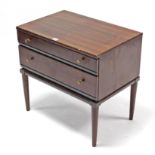 A mahogany two-drawer cutlery chest, on short round tapered legs, 23¾” wide x 22¾” high; a black