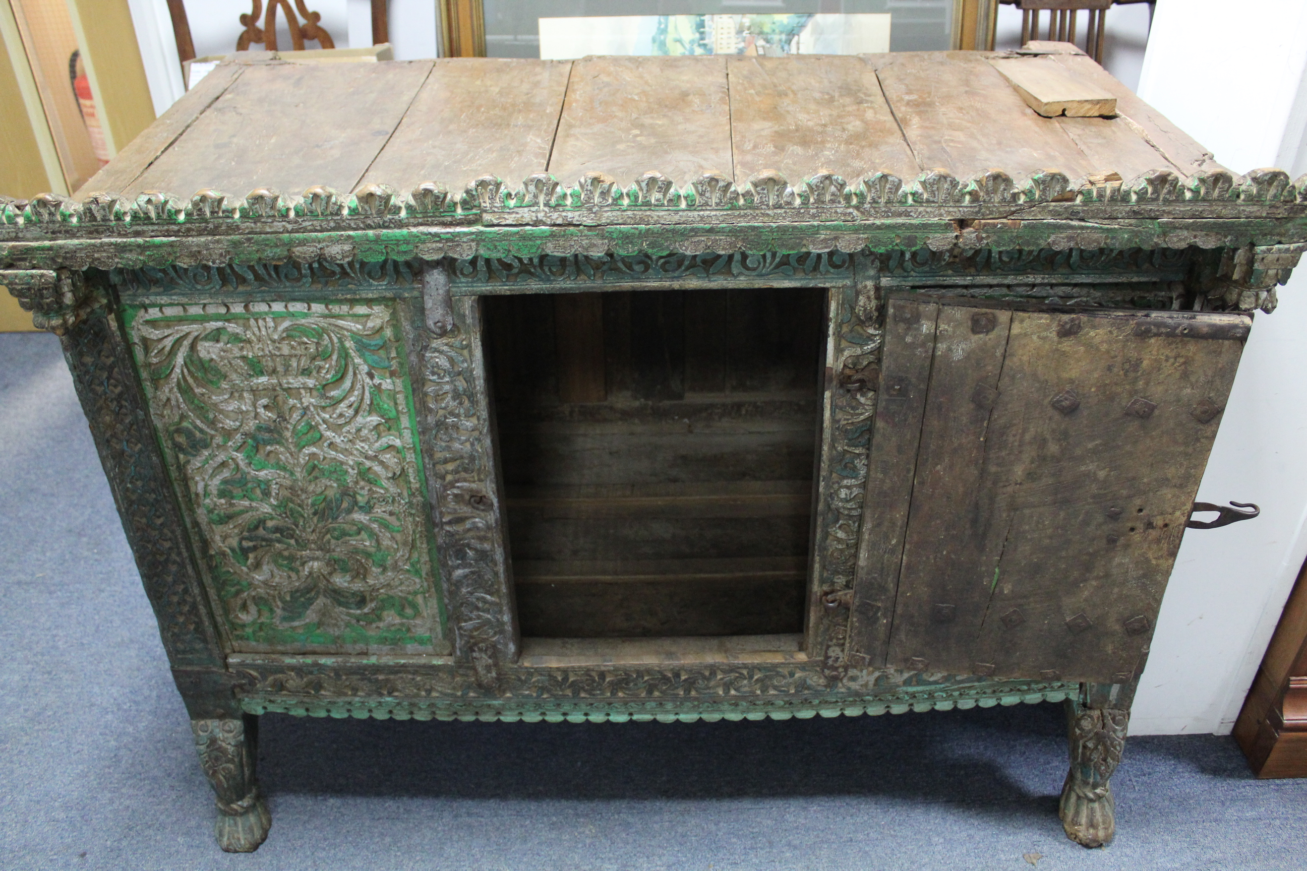 AN ANTIQUE INDIAN GREEN & GREY PAINTED & CARVED HARDWOOD LOW CABINET, ENCLOSED BY CARVED PANEL DOOR, - Image 3 of 4