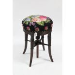 A 19th century rosewood piano stool with gros-point floral embroidered cover to the revolving