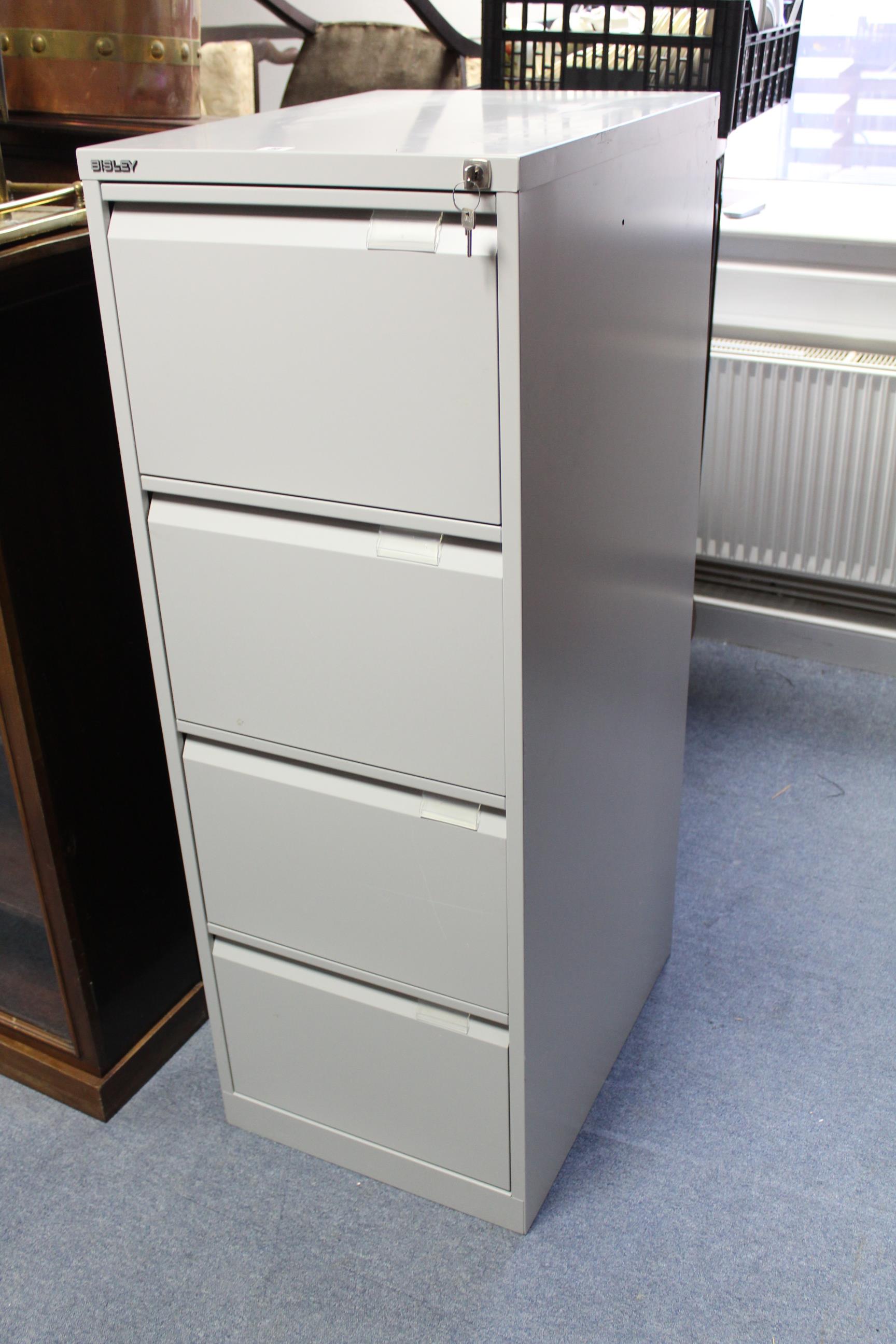 A Bisley grey art-metal four-drawer filing cabinet, 18½” wide x 52” high, with two keys.