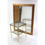 A large pine frame rectangular wall mirror, 52½” x 41½” & a brass square two tier occasional table