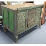 AN ANTIQUE INDIAN GREEN & GREY PAINTED & CARVED HARDWOOD LOW CABINET, ENCLOSED BY CARVED PANEL DOOR,