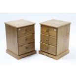 A pair of pine three-drawer bedside chests, each on shaped plinth base, 16¾” wide x 24½” high.