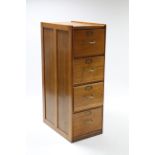 A light oak four-drawer filing cabinet, 17¾” wide x 51½” high.