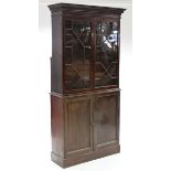 An early 19th century mahogany bookcase, with dentil cornice, fitted three adjustable shelves