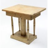 A pine kitchen table with rectangular fold-over top, & on five square supports & stepped rectangular