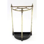 A brass demi-lune five-division umbrella stand on three round supports, 15½” wide x 25½” high.