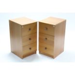 A pair of mahogany-finish three-drawer bedside chests, 15¾” wide.