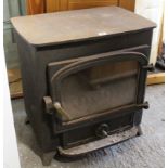 A cast-iron stove enclosed by glazed door, 22¼” wide x 23” high.
