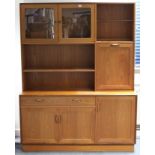 A G-Plan teak tall wall unit fitted with an arrangement of drawers, cupboards, & open shelves, 54”