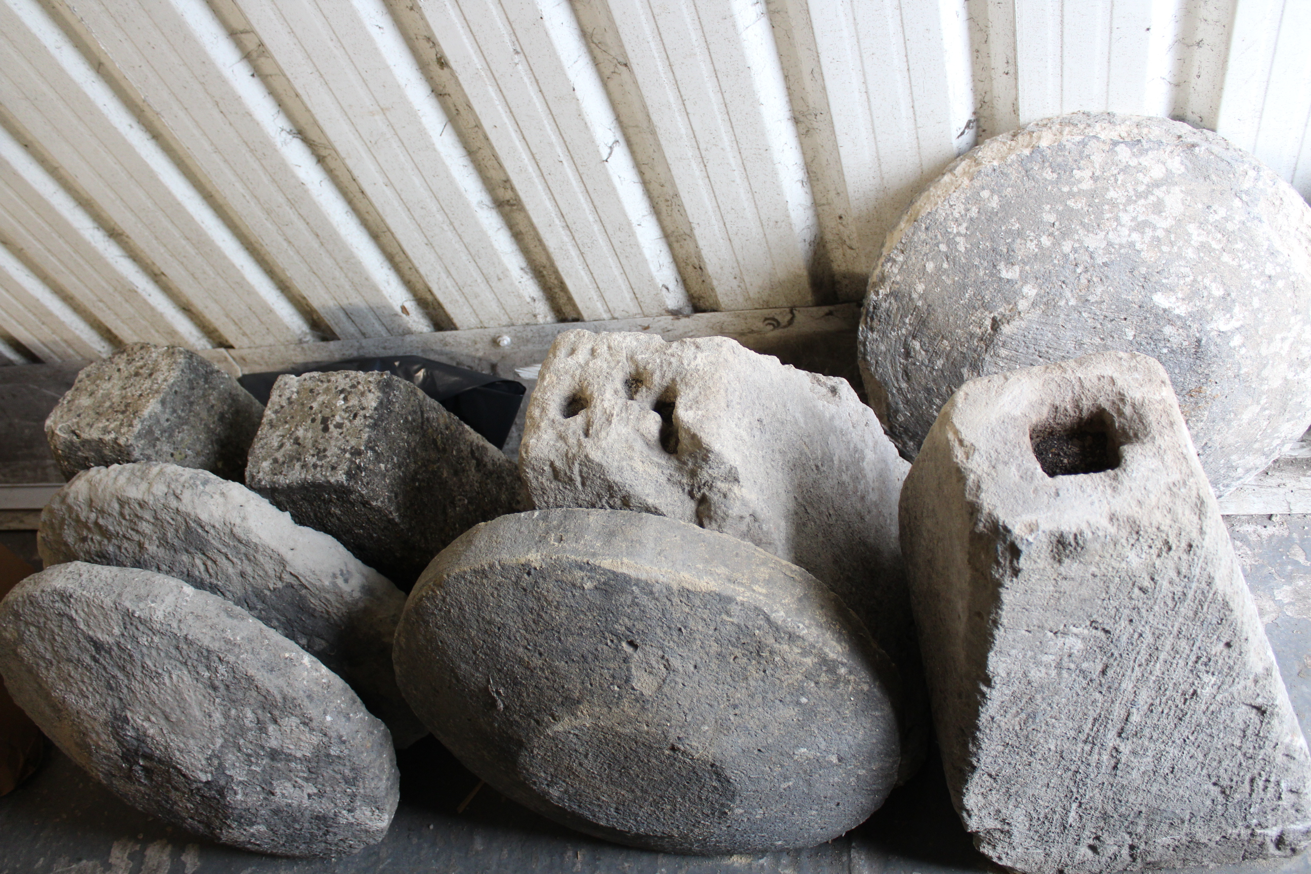 Four cast-stone staddle stones (various sizes); & a staddle stone top, part w.a.f.