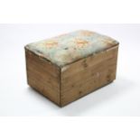 A deal storage box with hinged lift-lid upholstered in floral material, 36” wide x 20½” high.