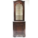 A reproduction mahogany tall standing corner cabinet, the upper part fitted two shelves enclosed